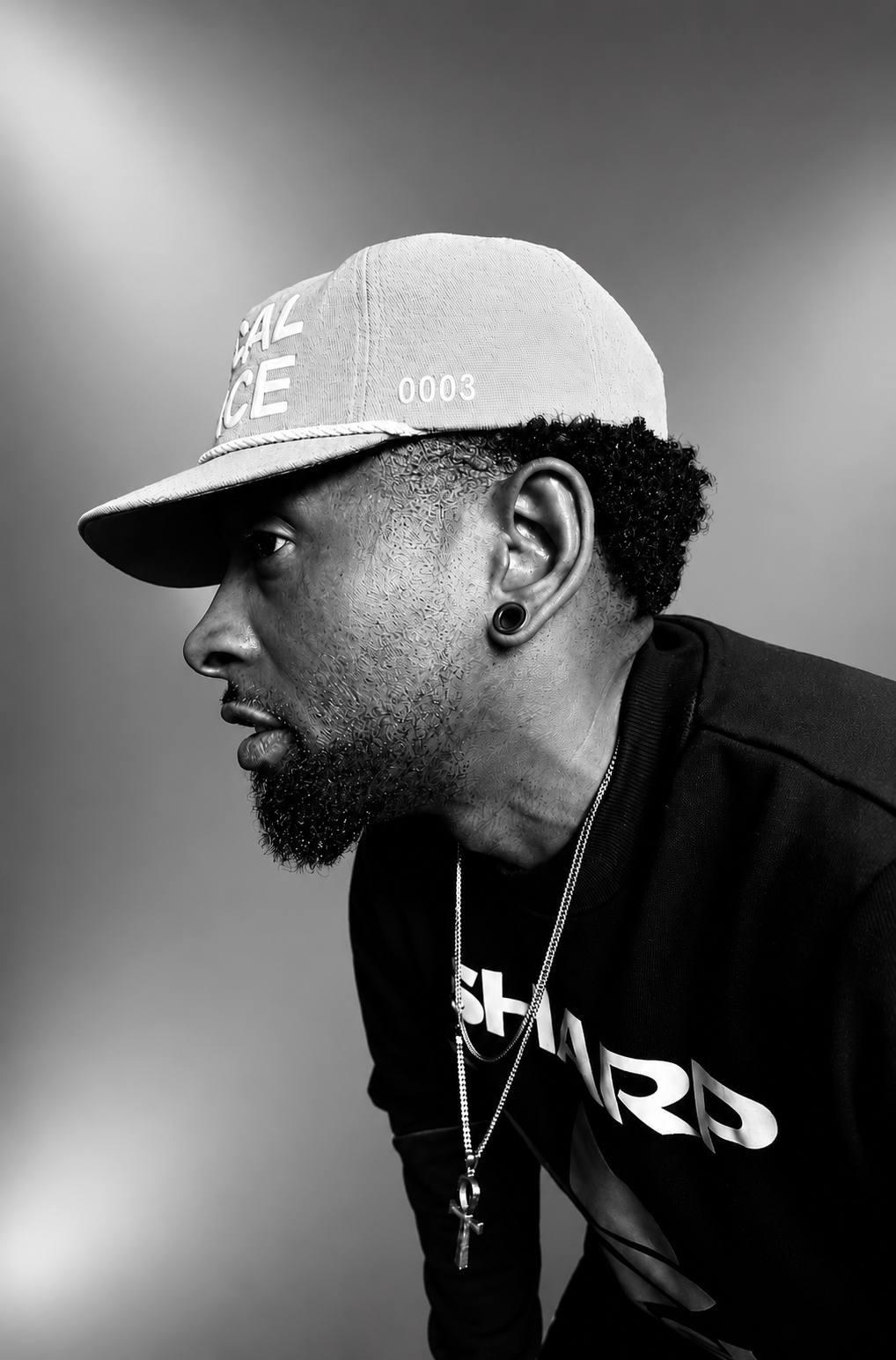 DJ T.REX in profile wearing a cap
